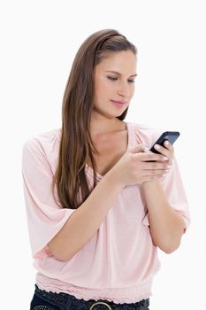Close-up of a girl typing a text message against white background
