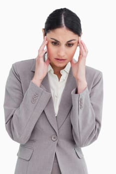 Young saleswoman experiencing a headache against a white background