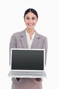 Smiling businesswoman showing screen of her laptop against a white background