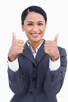 Close up of smiling saleswoman giving thumbs up against a white background