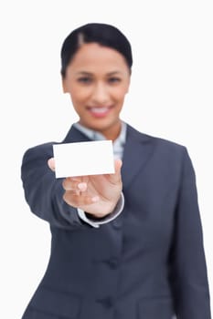 Close up of business card being shown by saleswoman against a white background