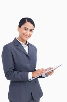 Close up of saleswoman with pen and clipboard against a white background