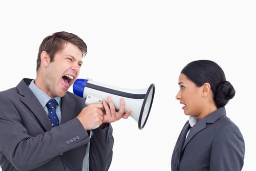 Close up of salesman with megaphone yelling at colleague against a white background