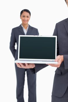 Close up of laptop being presented by salesteam against a white background