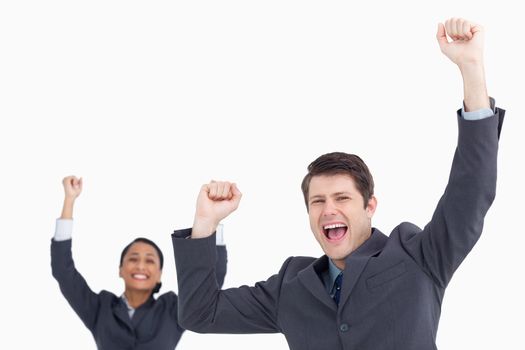 Successful salesteam cheering against a white background