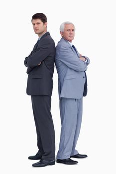 Businessmen standing back to back against a white background