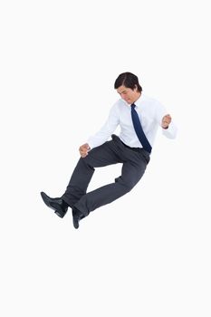 Successful tradesman clicking his heels against a white background