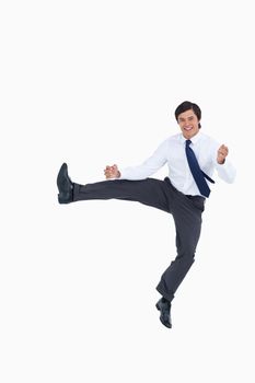 Happy jumping tradesman against a white background
