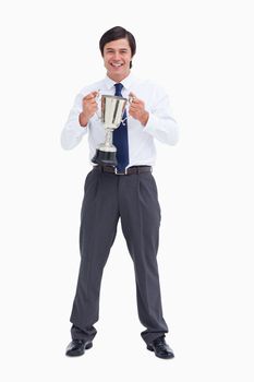 Smiling tradesman holding cup against a white background