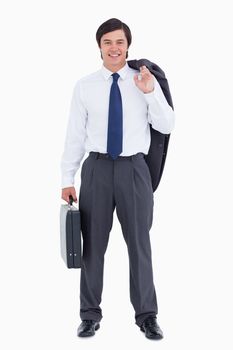 Smiling tradesman with suitcase and jacket against a white background