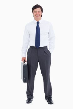 Smiling tradesman with his suitcase against a white background