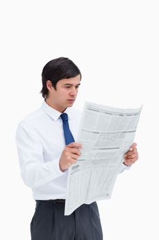 Young tradesman reading the news against a white background