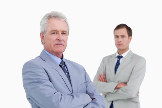 Serious tradesmen with arms folded against a white background