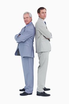 Side view of tradesmen standing back to back against a white background