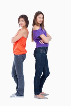 Teenagers standing back to back while wearing casual clothes