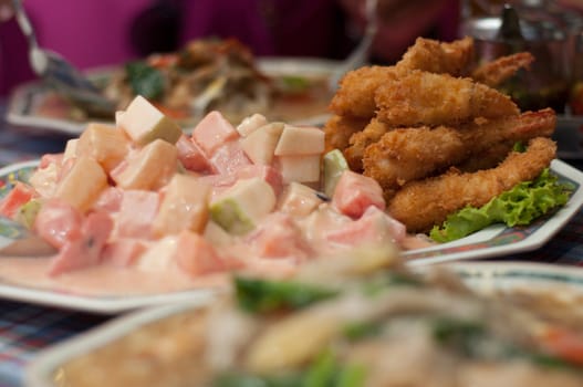 fried shrimp and fruit salad on dishes