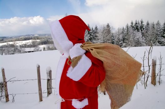 Santa Claus, Father Christmas in a beautiful winter landscape