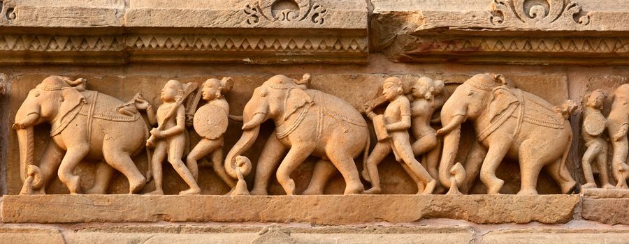 Stone carving bas relief panorama, Lakshmana Temple, Khajuraho, India. Unesco World Heritage Site
