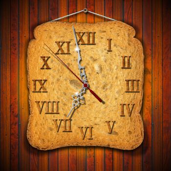 Watch made with a rusk on wooden background
