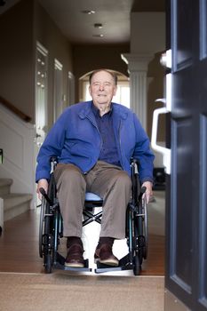 Elderly 90 yr old man in wheelchair at his front door