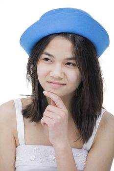 Beautiful young teen girl in blue hat, looking over with doubtful expression.Isolated on white