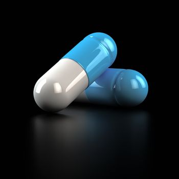 Two big pills on the black background