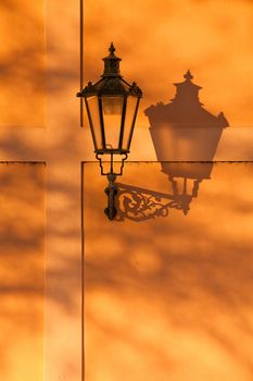 The lantern with its shadow on the yellow wall, Prague