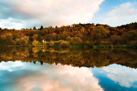 Reflection on the Berounka river in autumn at sunrise