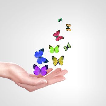 Human hands releasing a colourful butterflies illustration