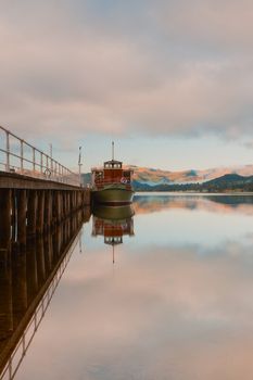 Scenic view of boats moored by wooden pier , Lake District National Park, England.