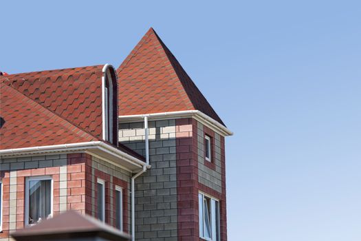 red roof of the modern brick suburban home