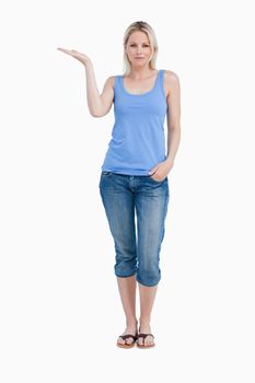 Relaxed blonde woman placing her hand palm up against a white background