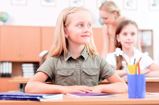 portrait of students in the classroom, sit at school desks