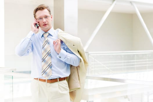 Smiling business man, talking on cell phone