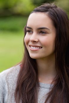 Thoughtful young woman standing in the countryside while looking away