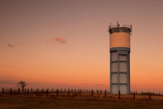 Historic water reservoir brick tower at sunset