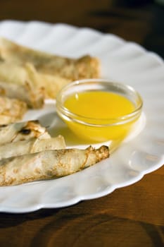 Pancakes on a plate with honey