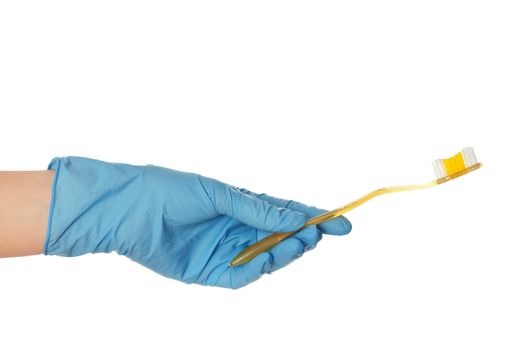 yellow brush for toothpaste in the doctor's hand