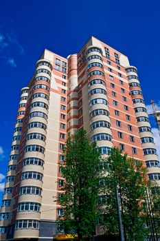 High modern apartment building under blue sky