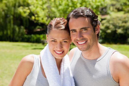 woman with towel on her shoulder smiling with a man
