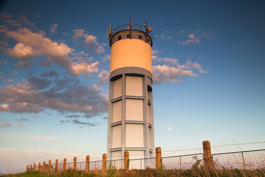 Historic water reservoir brick tower at sunset