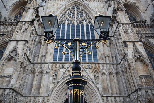The oak entrance doors and west stained glass window at York Minster Cathedral, York, England