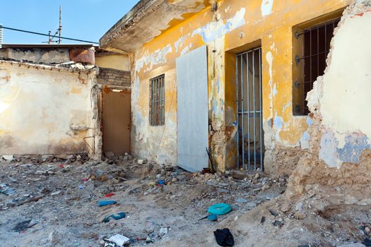 Old destroyed house and trash around .