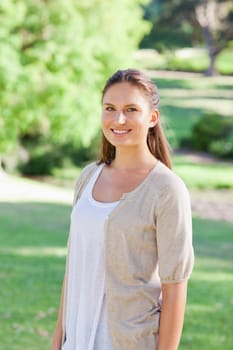 Smiling young woman spending her time in the park