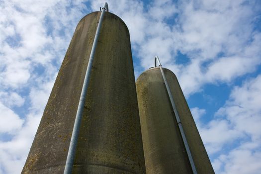 Agriculture farm grain silos in vertical angle facing the sky