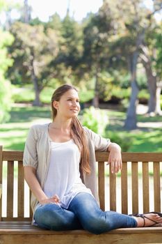 Young woman relaxing on a park bench