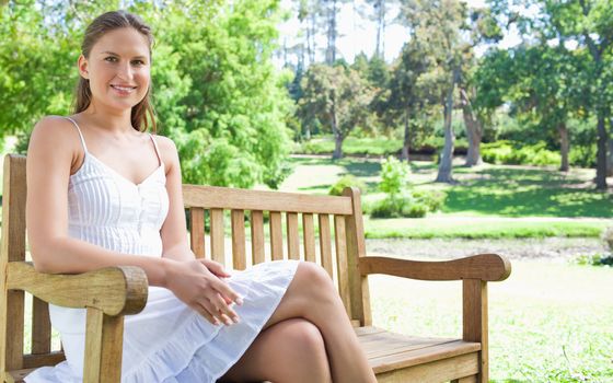 Young woman enjoying her day on a park bench