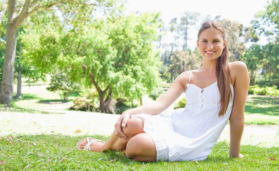 Smiling young woman relaxing on the lawn