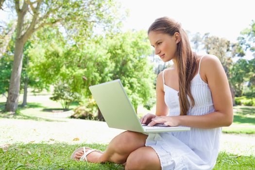Young woman on the lawn with her notebook
