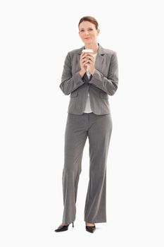A businesswoman is holding a cup of coffee with her both hands